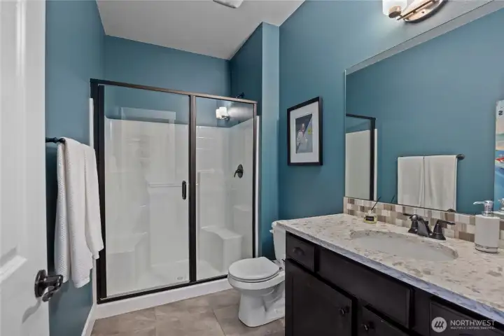 Main floor 3/4 bathroom -- perfect location if you're using the den as a guest room/ 4th bedroom.