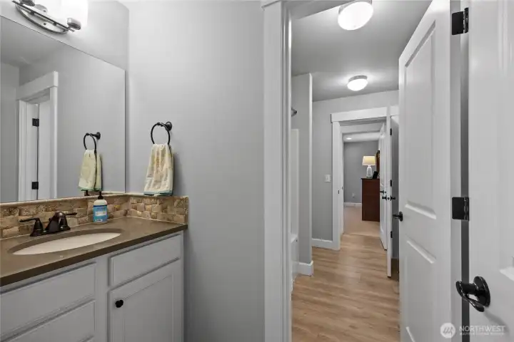 The 2nd bathroom upstairs is  Jack & Jill style, with doors leading to 2nd and 3rd bedrooms, each with it's own sink & toilet.