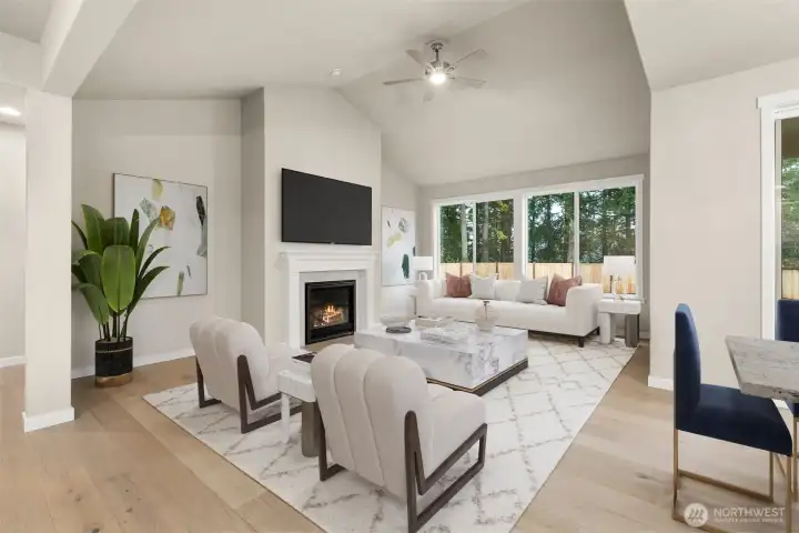 Spacious Living Room with hardwood floors, gas fireplace, oversized and wood wrapped windows.