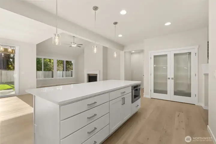 Kitchen island perfectly positioned in this open floor plan concept. Notice the generous use of hardwood floors.