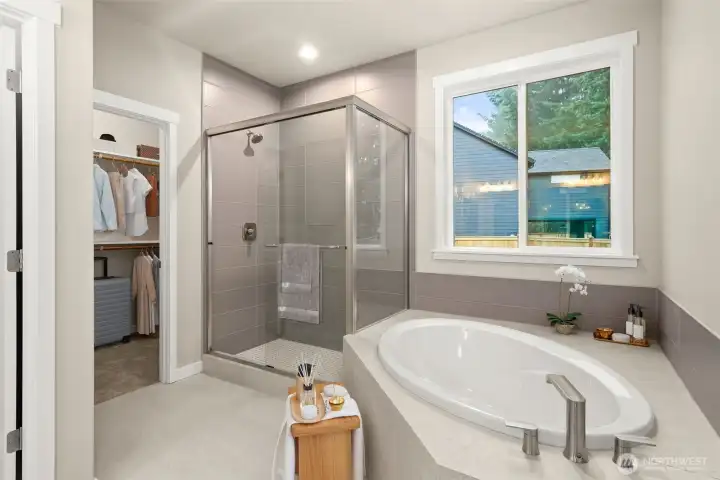 Primary Bath with soaking tub, tile shower and walk-in closet.