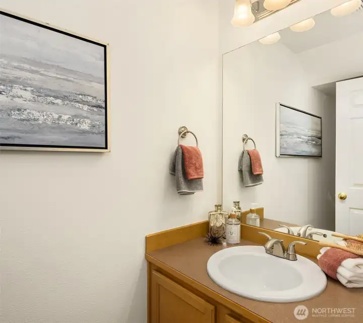 Rounding out the main level is this powder room that is located off the entry. Rounding out the main level is this powder room that is located off the entry.