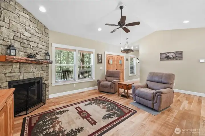 Bright living room with floor-to-ceiling river rock fireplace