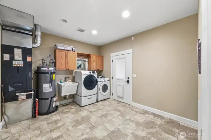 Large laundry & utility room with access door to backyard