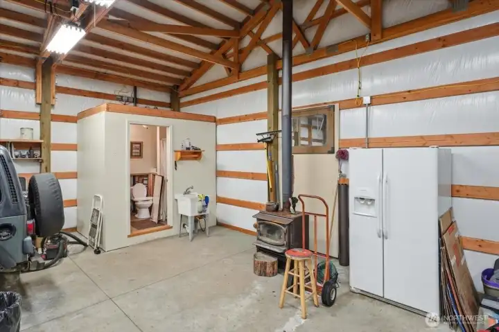 Shop includes wood stove, workspace and bathroom