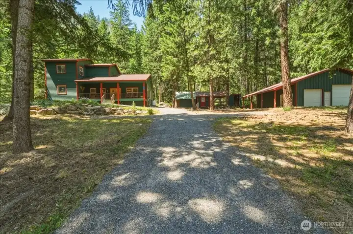 Custom home and detached shop nestled among the pines