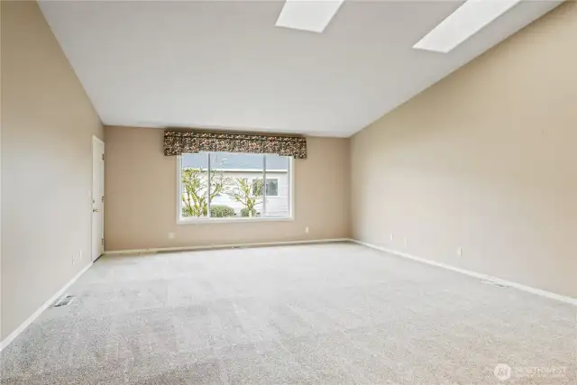 Spacious living room with skylights
