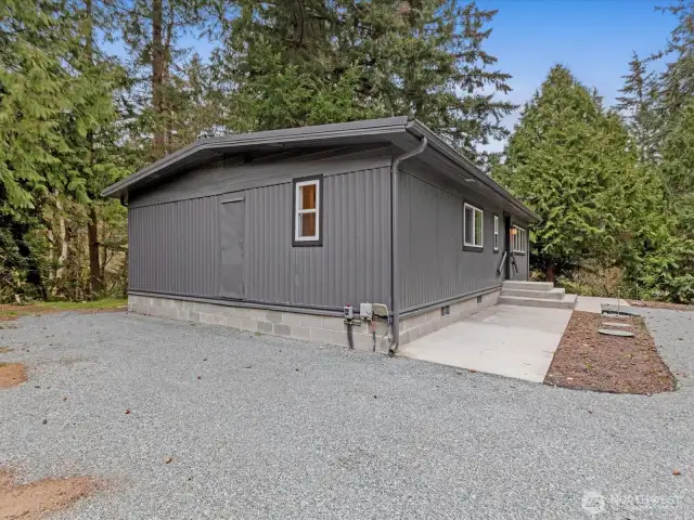 Parking area and paved walk to the front door.