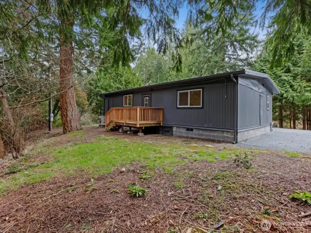 Rear deck with entry door to kitchen. perfect for a BBQ.