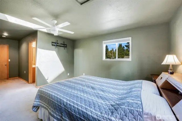 Primary suite with skylights and attached 3/4 bath