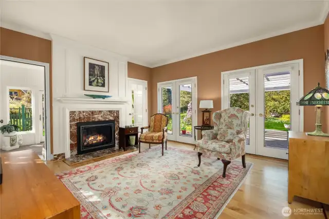 Sitting room off the kitchen is cozy with the propane fireplace. Open up the double french doors and enjoy the arbor and gardens.