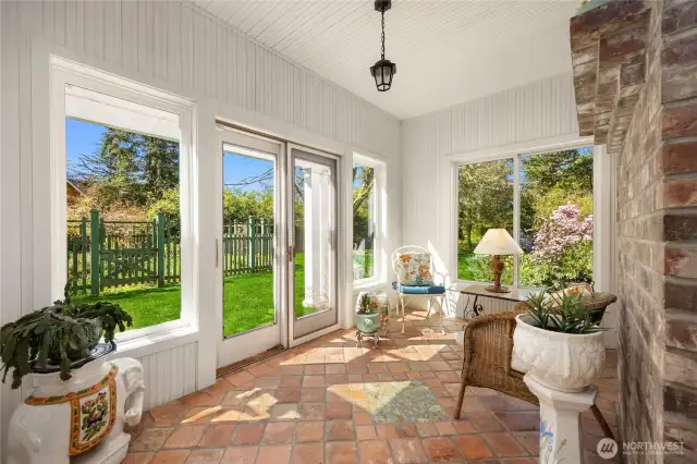 A three season sunroon room on the south side of the home .