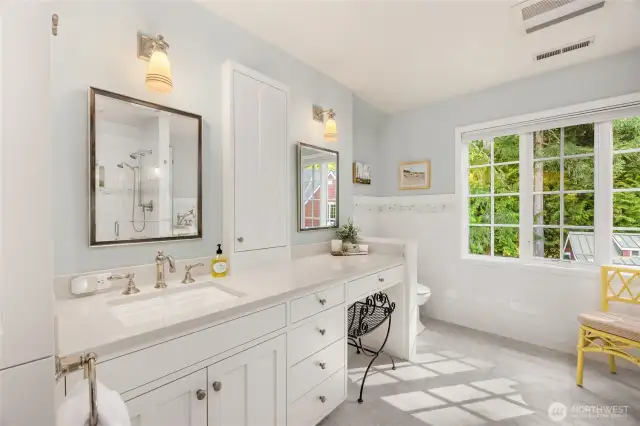 The spacious primary bathroom is light and bright.