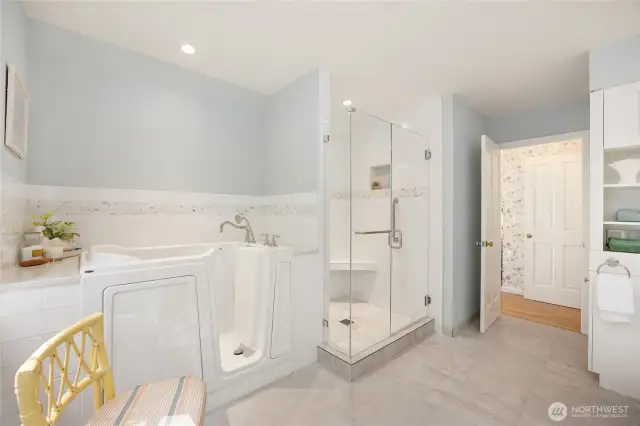 Primary bath features easy access bath, gorgeous tile shower, tile floors.
