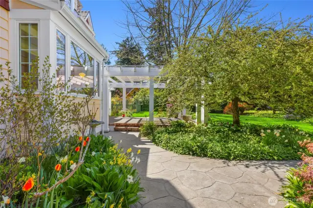 Patio off the formal living room connects to the arbor off the Kitchen and family room