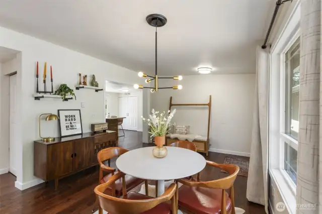 Dining area with newer lighting and beautiful hardwood flooring!
