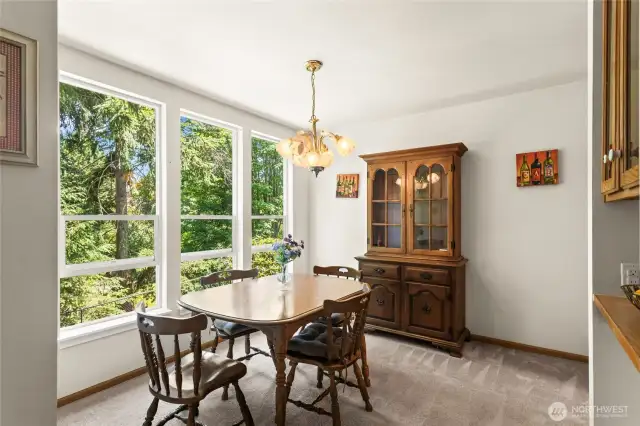 Cheery dining with lots of natural light overlooking lush greenery of the community park