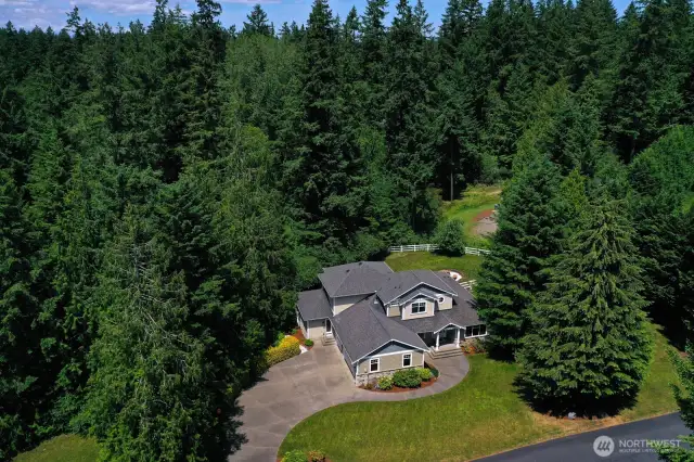 A secluded Pacific Northwest gated retreat nestled in lush evergreens, this beautifully maintained home features a spacious layout, manicured landscaping, and a private driveway. Surrounded in a mature forest like setting, the property offers serene privacy just minutes from town.