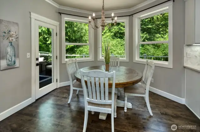 Charming spacious breakfast nook offers a bright and peaceful setting to start your day, with direct access to the outdoor deck for seamless indoor-outdoor living.