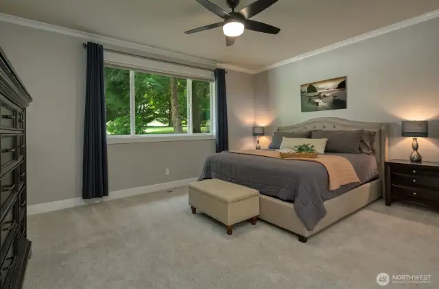 Retreat to the spacious main level primary suite featuring cozy plush carpeting, soft natural light, serene views, and a calming color palette—your own private haven.