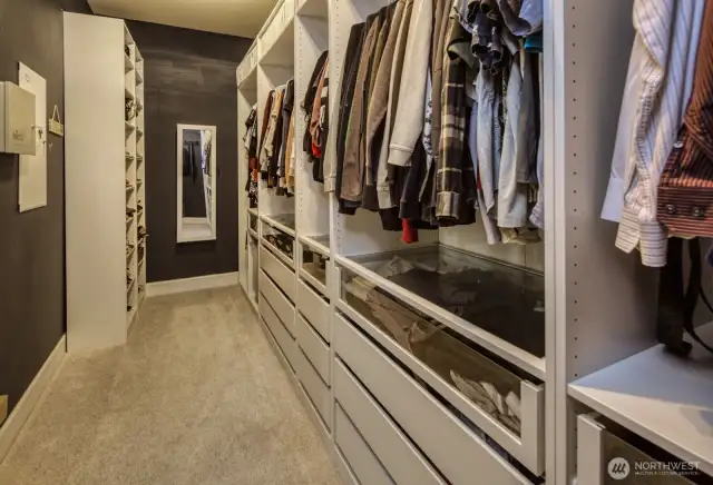 Expansive walk-in closet offers custom built-in shelving, drawers, and hanging space—perfectly designed for effortless organization and everyday convenience.