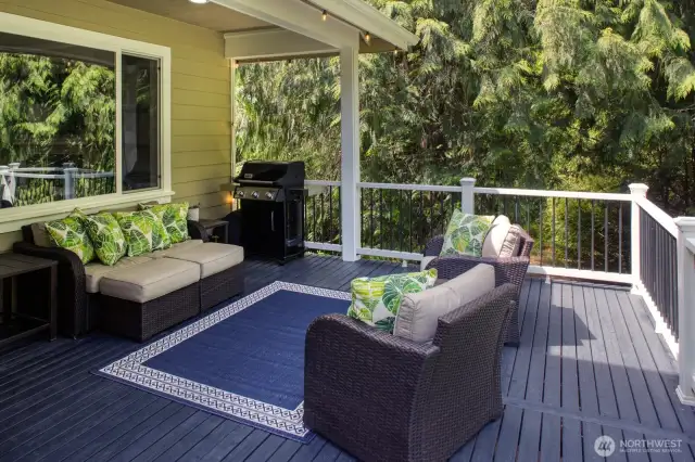 Relax and entertain year-round on the spacious covered deck, complete with a grill area; ultimate privacy and tranquility.