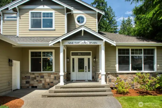 Welcome guests with this inviting front entry, featuring a wide stairway, that perfectly complements the natural surroundings.