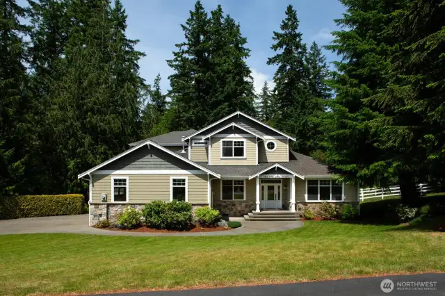 This beautifully maintained craftsman-style home in the gated Somerford Estate is nestled on a spacious, private lot just over one acre surrounded by lush evergreens. Featuring a charming covered entry, stone accents, and a manicured front lawn, this property offers peaceful Pacific Northwest living with refined curb appeal.