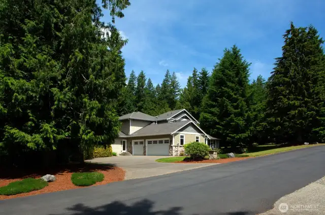 A spacious three-car garage and large driveway provide ample parking and ease of access.