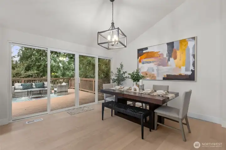 Your dining room looks out over a huge new entertaining deck with a wall of windows and double sliders.