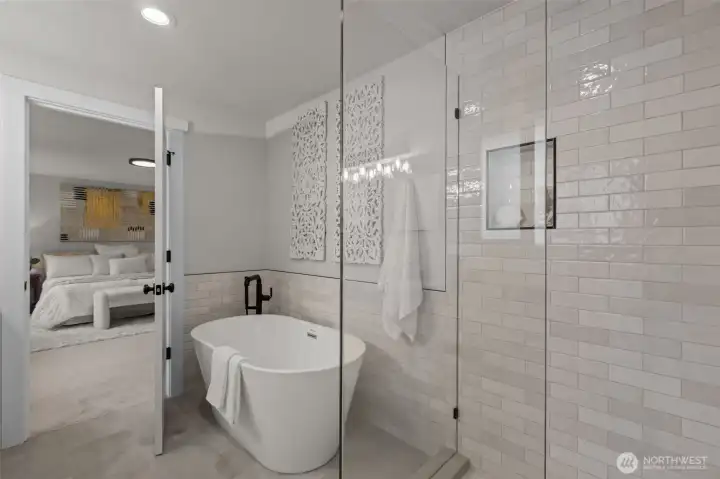 Enjoy your own personal spa with this gorgeous glassed in shower and free-standing bathtub.