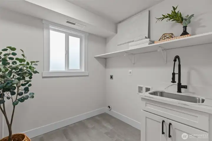 This light, bright utility room even features a laundry-chute from the bedroom wing upstairs!