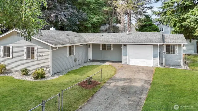 Cedar siding, freshly painted. New gutters. Over-sized one car garage with insulated door plus plenty of driveway parking. Green grass has been digitally altered in photo.