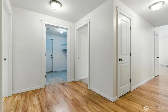 from left, 2nd bedroom, laundry door (also to garage), 3rd bedroom, hall to great room.