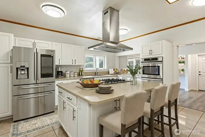 This is a HUGE kitchen with stainless appliances and solid surface countertops. SO much storage! Digitally staged