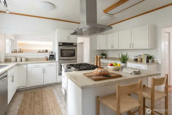 Spacious kitchen (digitally staged) Double ovens and gas stovetop are very handy features!