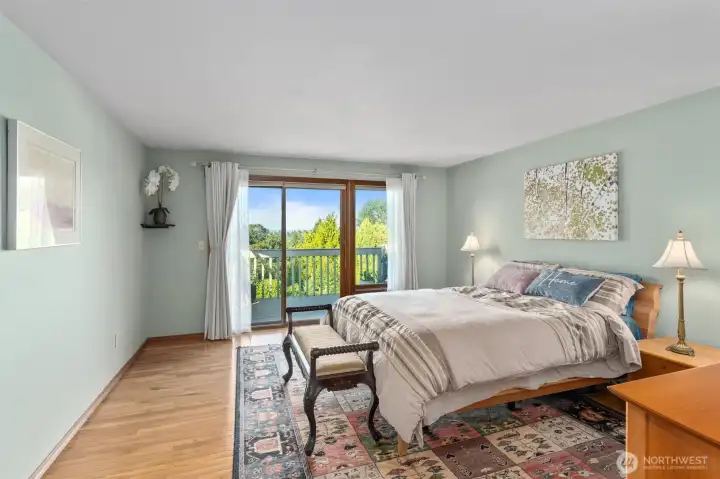 Main Floor primary bedroom suite with slider doors to deck.