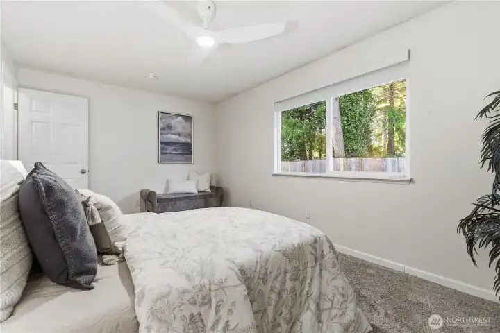 Large window in this Primary bedroom views the fenced rear yard.