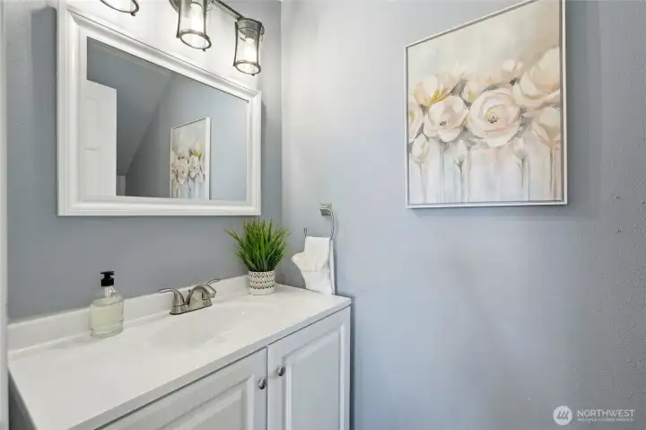 Convenient main-level half bath for guests.  Updated finishes give it a clean, modern feel.