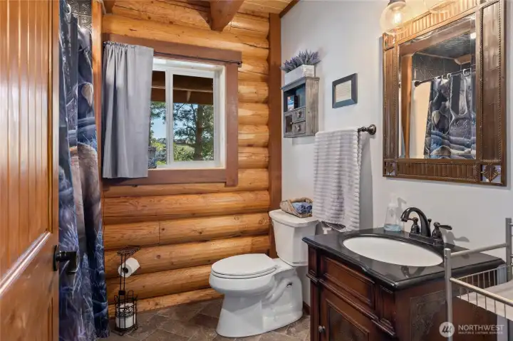 Main floor has a full bathroom. Builder included sheetrock to accent the logs to make for a elegant restroom.
