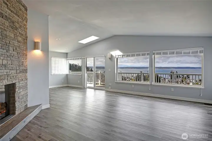 Open living room to view and dinning area with fireplace