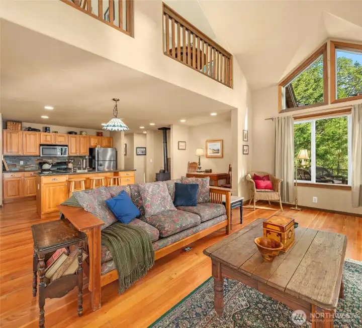 Living flows to open kitchen; note peekaboo views from upper bedrooms