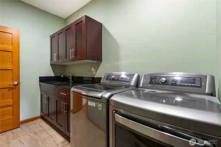 Main level laundry with beautiful cabinet space Main level laundry with beautiful cabinet space