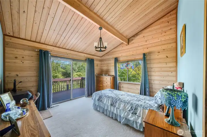 Primary suite with vaulted ceilings and deck access Primary suite with vaulted ceilings and deck access