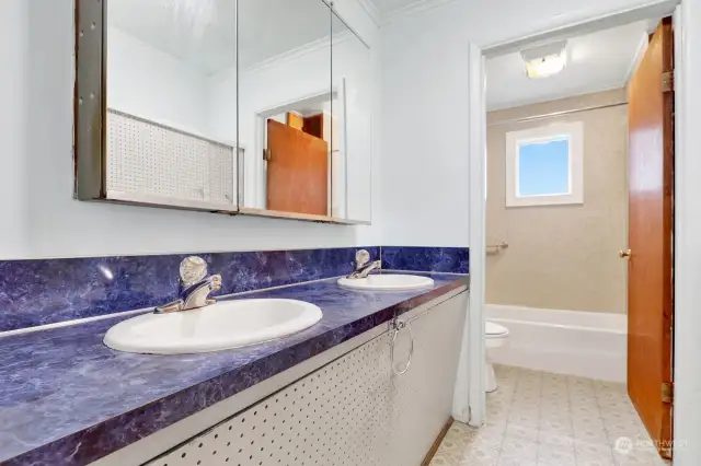 Full bathroom with double sinks & shower/ tub