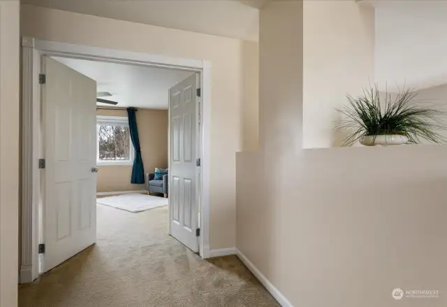 At the top of the landing - Double doors open to the primary suite, creating a striking and elegant entrance that sets the tone for this peaceful retreat.