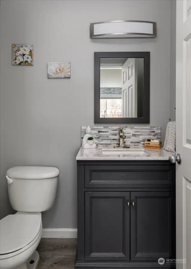 Beautiful and modern half bath off the kitchen.