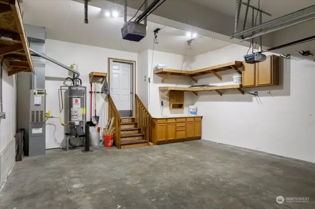 Double car garage offers plenty of room for parking and storage, complete with additional shelves to keep everything organized and easily accessible.