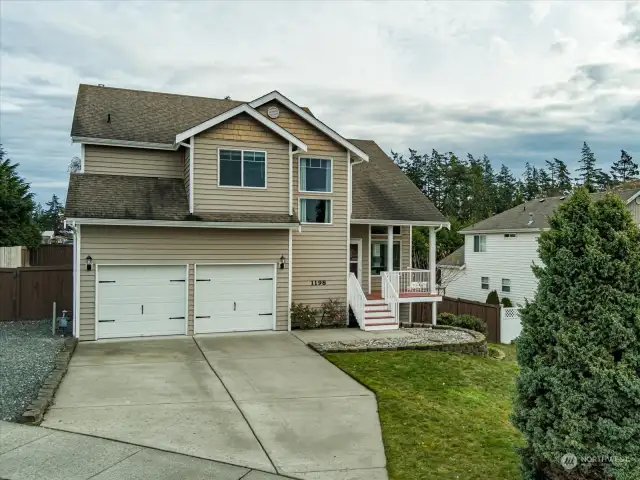 Front yard beautifully frames the driveway and entrance, setting the stage for the stylish home that awaits your tour at 1198 Kathleen Drive. Welcome home! Welcome to Whidbey Island!