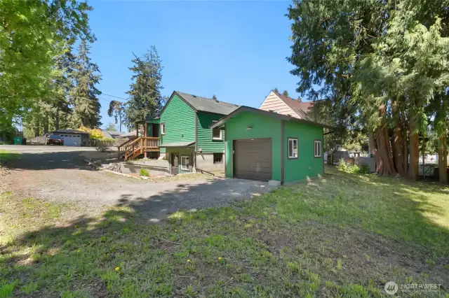 View of yard, home and garage